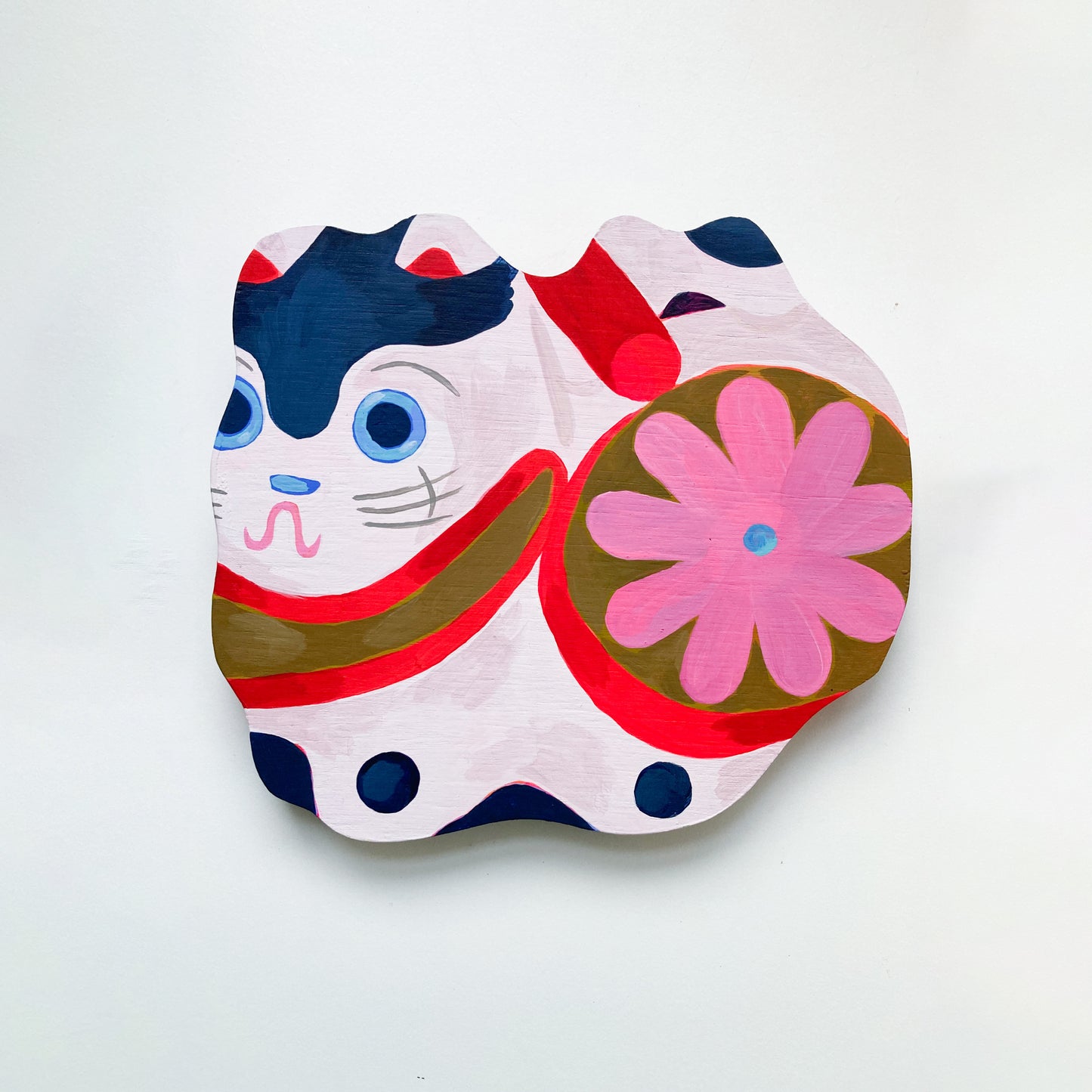 A colourful little 'dog', inspired by Japanese Hariko Inu folk toys.